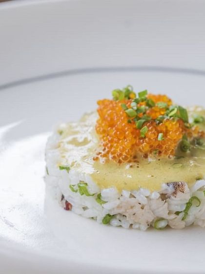 A dish of rice topped with roe, an example of the gourmet offerings at our exclusive chef-led events.