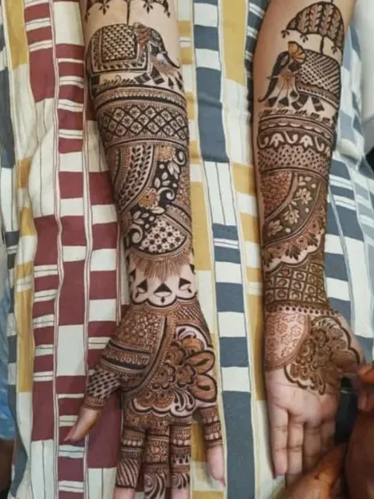 A full-arm design in progress, showing a mix of traditional elements like the baraat elephant and intricate paisley patterns.