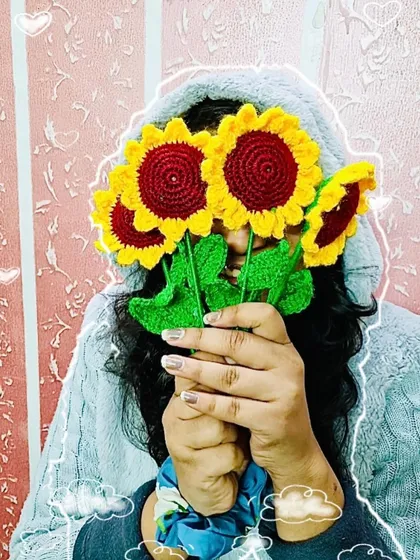 Having some fun posing with my handmade crochet sunflowers. Each one is crafted with bright, cheerful colors.