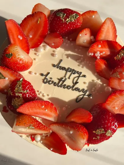 A seasonal favorite, this Vanilla Strawberry cake is topped with fresh strawberries, edible gold leaf, and tiny sugar pearls. It's available as a celebration cake or a smaller bento cake.