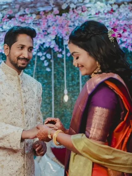 Srushti and Nikhil during their ring ceremony. I focus on the gentle interaction and happy smiles as they formalize their commitment in front of family and friends.