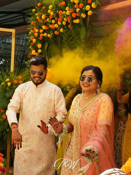 A grand entrance for the couple at their Haldi ceremony, walking through a cloud of colorful smoke. It’s all about making a statement.