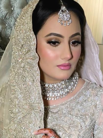 A side profile showcasing the soft golden eye makeup and the subtle contouring. This look is all about luxury and elegance.