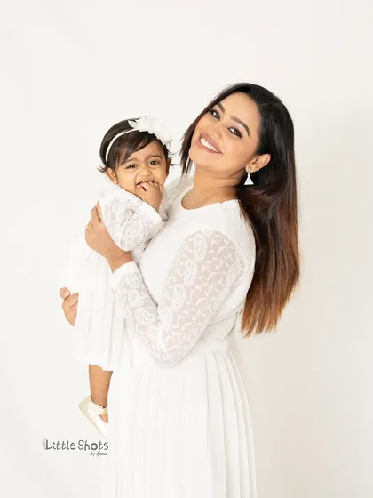 There is nothing more special than the bond between a mother and her child. In this simple and elegant studio portrait, I focused on capturing that beautiful connection and shared smile in a timeless, all-white setting.