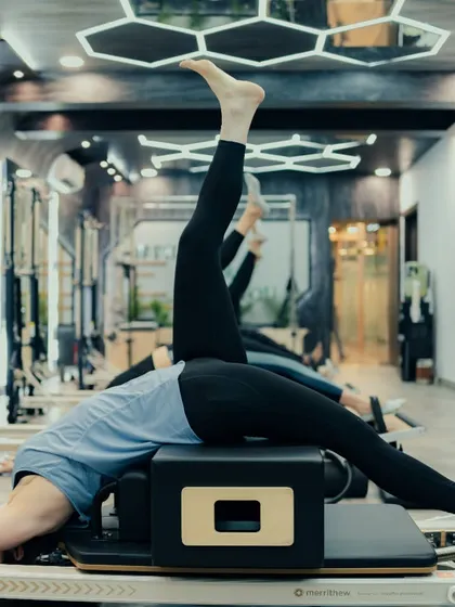 A look at our reformer setup during a group class. This exercise focuses on leg and glute strength, with each client able to work at their own pace while maintaining proper form.