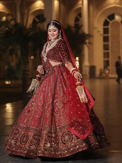 A full-length view of the bride, showcasing her regal posture and the magnificent lehenga. The makeup ties the entire royal look together.