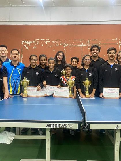 The entire team posing with their trophies and medals.