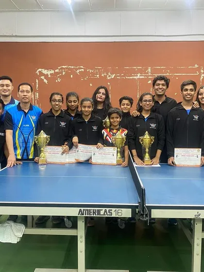 The entire team posing with their trophies and medals.