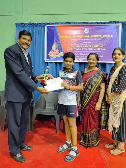 Sharvil K receiving his trophy after winning silver medals in both U11 and U13 boys categories at the Mysore state ranking.