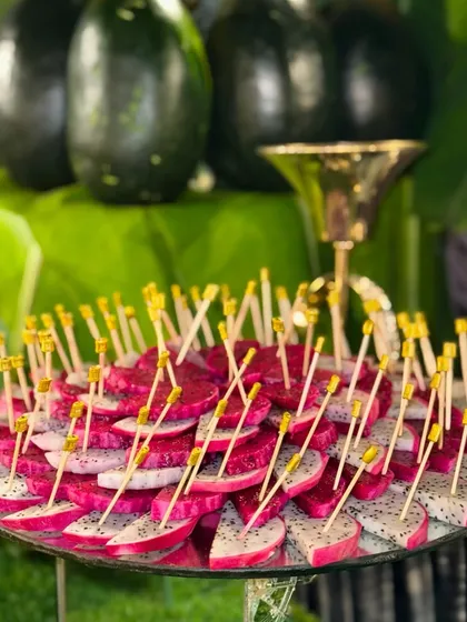 A beautiful arrangement of freshly sliced dragon fruit, ready to be served. The vibrant pink and white colours make it a visually appealing and healthy option for guests.