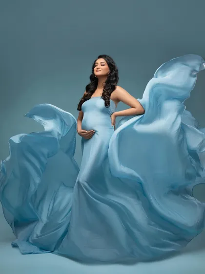 Another angle of the flowing blue gown, showing how we can create different shapes and moods. This pose is all about capturing a sense of strength and grace.