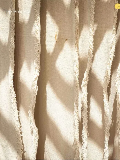 A close-up of the rug-making process, showing the texture and detail that goes into each piece.