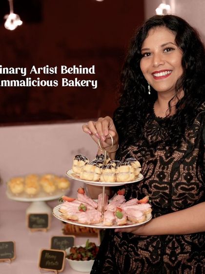 Here I am, the culinary artist behind Mummalicious, presenting a tiered stand of our popular profiteroles and strawberry eclairs at a catered event. We take pride in both the taste and presentation.