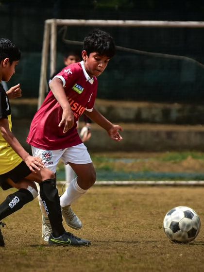 A player dribbles past a defender in an RSA Cup match. Moments like these showcase the 1v1 skills and confidence our players develop.