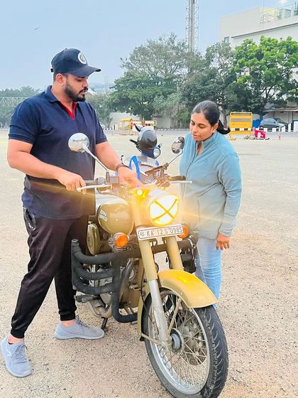 Checking the bike's lights before a ride. Safety is a habit, and I teach my students to perform these simple but vital pre-ride checks every time.
