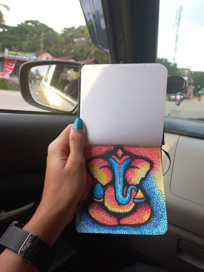 A small Ganesha artwork created using a dot art technique with acrylic pens. This piece was done in my sketchbook while traveling, making it a perfect example of art on the go.