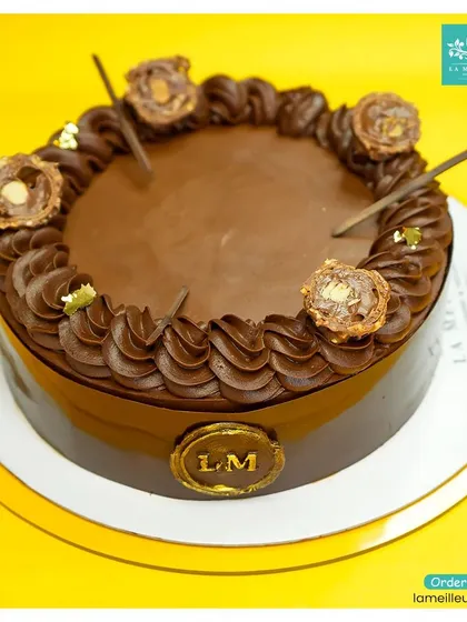 The ultimate indulgence for chocolate lovers: our Ferrero Rocher cake. It's a rich chocolate cake decorated with chocolate piping and topped with whole Ferrero Rocher chocolates.