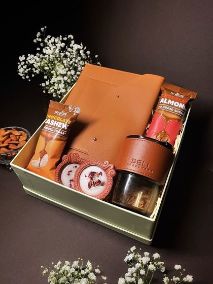The "Delightful Diwali" hamper combines practical leather goods with festive treats and decor, offering a balanced and thoughtful gift.