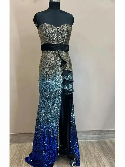 Get ready to shine at your next party with this glamorous sequin bodycon dress. This rental piece features a stunning gold to blue ombre effect and a thigh high slit, ensuring you will be the center of attention.