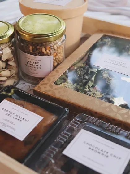 A closer look at a custom hamper, featuring Millet Trail Mix Namkeen, Chocolate Chip Brownies, and other assorted goodies.