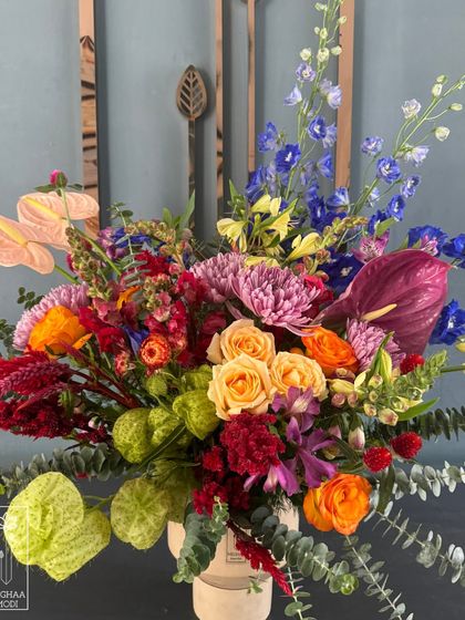 This vibrant, multi-colored arrangement exudes joy and energy. The bold mix of colors and textures creates a dynamic and celebratory mood, perfect for a festive occasion.