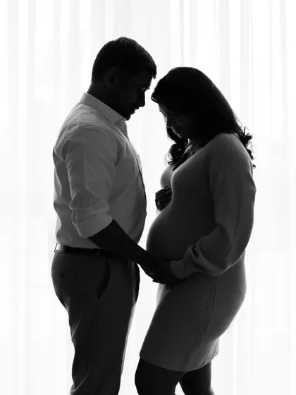 Sometimes, the most powerful stories are told in silhouette. This black and white portrait focuses on the beautiful shape of pregnancy and the intimate connection between the couple, creating a timeless and artistic memory.