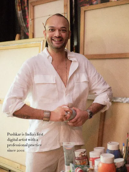 A happy, candid portrait of artist Pushkar Thakur in his studio. His smile and the creative chaos around him perfectly capture his vibrant energy.
