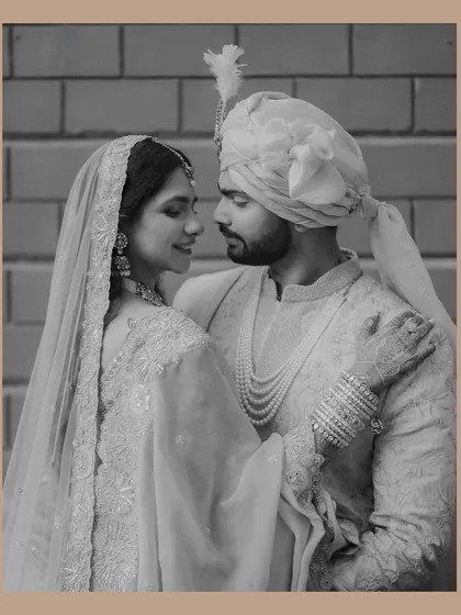 A timeless black and white portrait that feels like a classic film still. The soft light and the couple's gentle expressions create a romantic and elegant mood.