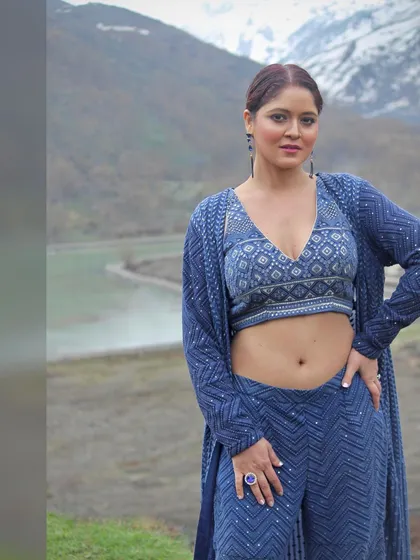 A three-quarter view of the blue co-ord set against a natural backdrop.