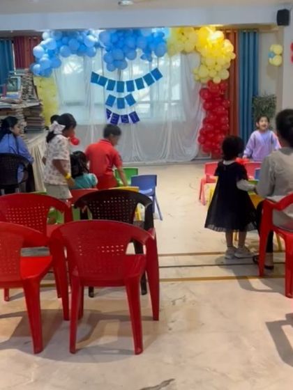 The room is buzzing with activity during the Lit Fest as children move between reading corners and craft tables.