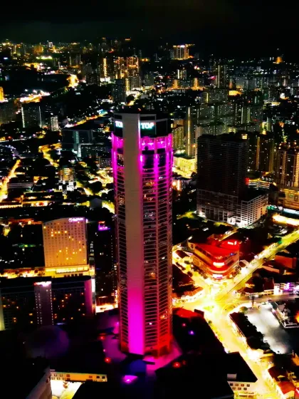 A night-time aerial photograph of Penang, Malaysia, showing the illuminated skyline and The TOP building. This was part of my collaboration with AirAsia.