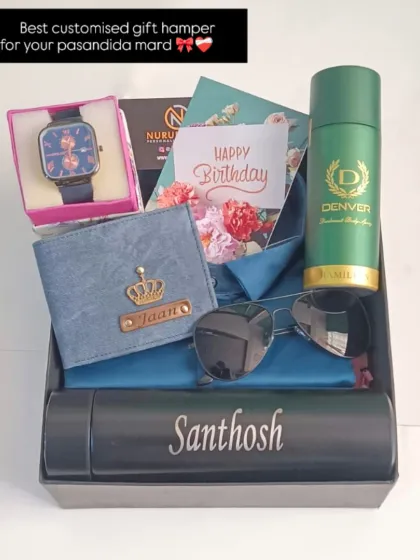 I love putting together these complete gift hampers. This one includes a personalized denim wallet, a name-engraved temperature bottle, a watch, sunglasses, and a men's deodorant, all beautifully arranged for a special birthday surprise.