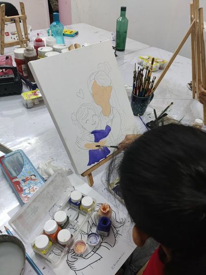 The beginning stages of a Mother's Day painting. A student fills in the base colors, getting ready to add the loving details.