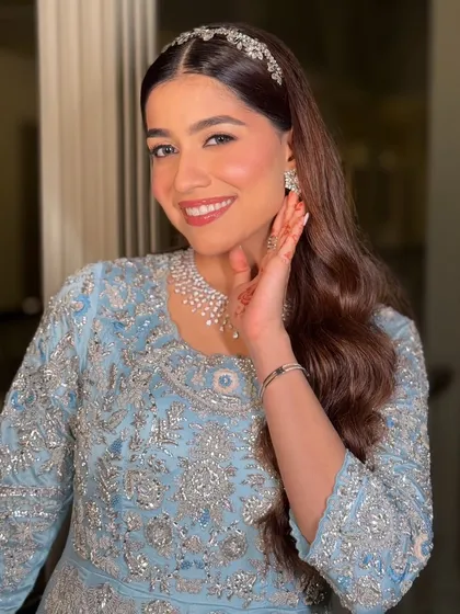 A happy, glowing bride. Her smile says it all. The makeup is designed to enhance her natural beauty and joy, creating a look that is truly unforgettable.