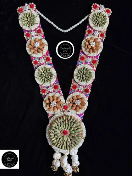 A vibrant and colorful elaichi and almond garland, perfect for celebrating the rich traditions of Holi.