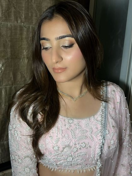 A closer look at the soft glam makeup. The glossy nude lip and perfectly blended eyeshadow create a look that is effortlessly chic and modern.