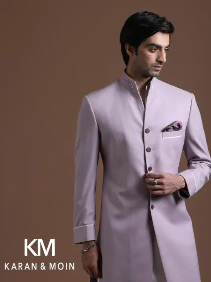 A classic bandhgala in a contemporary lilac hue. The clean lines, sharp tailoring, and asymmetrical button placket make this a standout piece. It is a modern interpretation of a timeless garment.