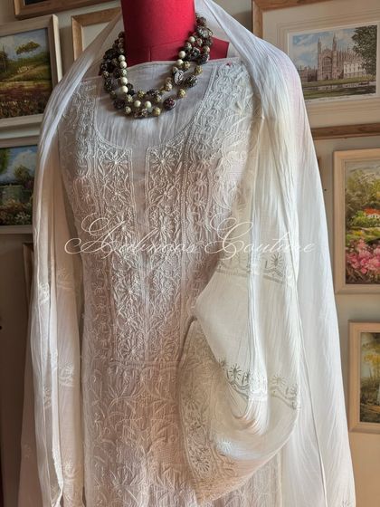 A full-length view of the off-white kurta set on a mannequin, demonstrating its graceful silhouette and classic appeal.