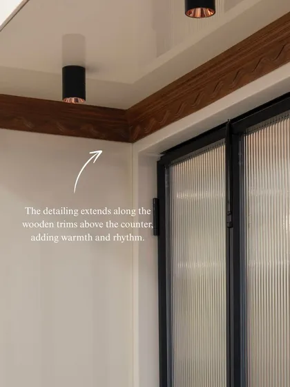 The scallop motif is a thread that runs through this kitchen, appearing here on the wooden trim above the counter. It’s a subtle, poetic detail that adds warmth, rhythm, and a unique personality to the space.