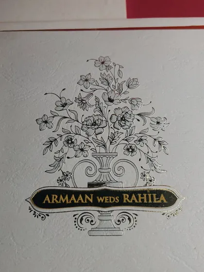 A closer look at the fine line work of the floral sketch and the embossed gold foil of the name banner. It's a timeless design that feels both personal and luxurious.