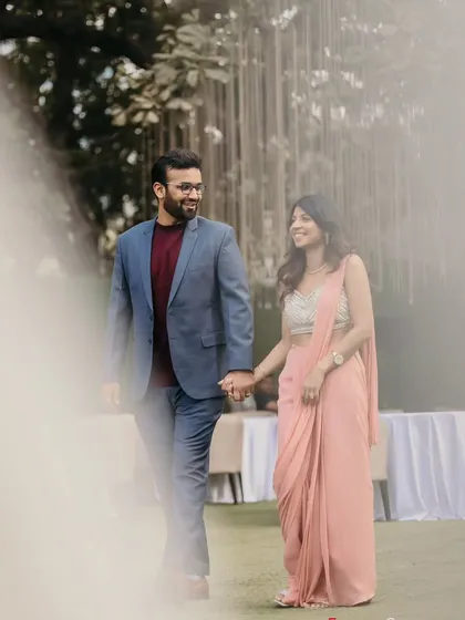 A candid moment of the couple walking hand-in-hand at their engagement. It's these simple, happy moments that build the story of your day.