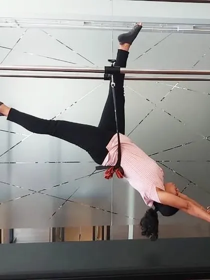 A client shares how Pilates helped her build a strong core for a trek. This hanging stretch on the Cadillac is part of her routine to maintain flexibility and strength.