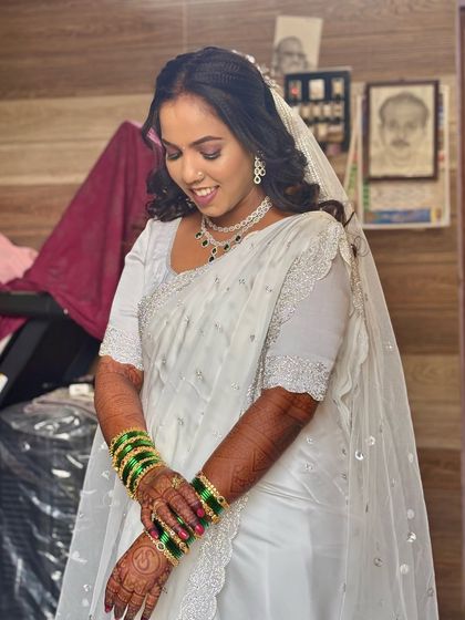 A candid moment of the bride looking down. The hairstyle is designed to look beautiful from all angles, even in quiet moments.