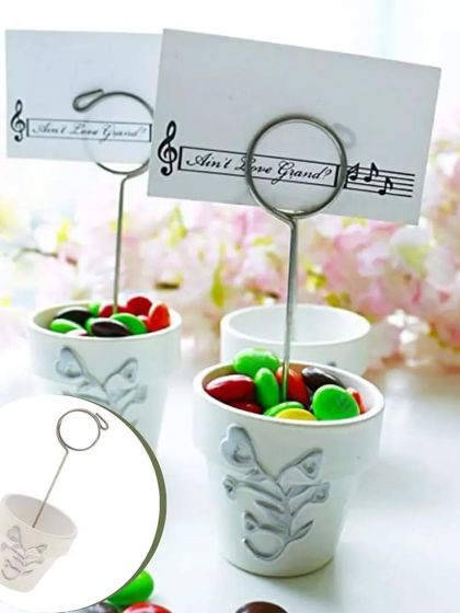 A sweet and simple design, these mini planter pot card holders can be filled with candies or a small succulent. They serve as both a place marker and a delightful favor for your guests to take home.
