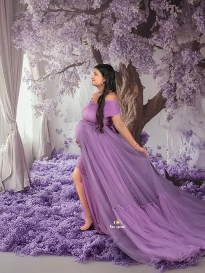 Our enchanting purple floral tree setup. The mom-to-be is surrounded by a carpet of blossoms, creating a magical, forest-like scene right in our studio.