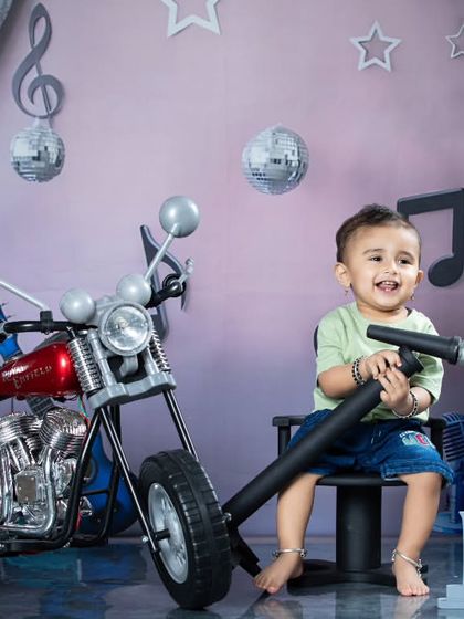 A happy moment from our rockstar session. The little one is enjoying the microphone, ready to sing his heart out.