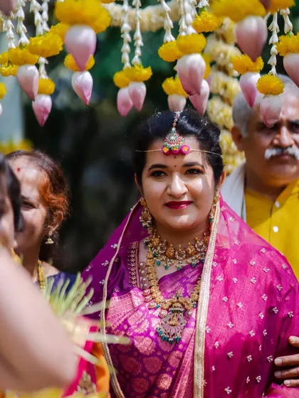 A candid shot of a gorgeous bride during her ceremony. The makeup, with its bold lip and defined eyes, ensures she looks stunning even in action shots.