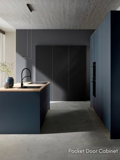 This image shows a pocket door cabinet in its closed state, seamlessly blending with the surrounding cabinetry for a clean, monolithic look.