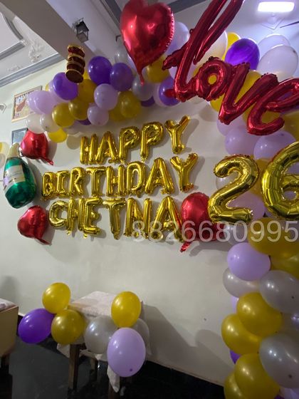 This view shows the full balloon arrangement, including the 'Love' and heart-shaped foils that add a romantic touch to the birthday celebration.