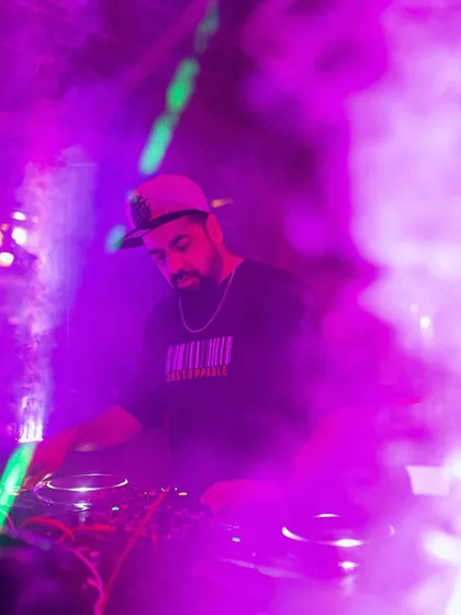 Me on the decks at Pebble, surrounded by purple smoke and lights.